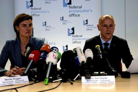 Federal Prosecutor Spokespersons Wenke Roggen, left, and Eric Van Duyse read a press release at the Belgium Federal Prosecutor Office in Brussels, Thursday, Oct. 11, 2018. Belgian authorities charged five people Thursday in relation to a massive financial fraud and match-fixing probe into soccer. (AP Photo/Francisco Seco)