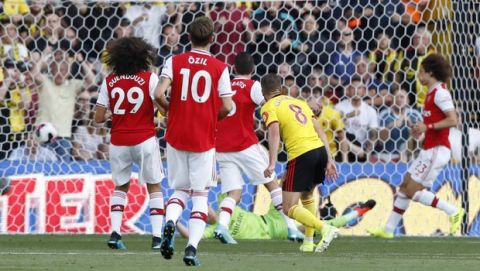 Watford's Tom Cleverly, (8), watches as he score his sides 1st goal of the game during their English Premier League soccer match between Watford and Arsenal at the Vicarage Road stadium in Watford near London, Sunday, Sept. 15, 2019. The match ended in a 2-2 draw. (AP Photo/Alastair Grant)