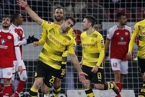 Dortmund's Sokratis, left, celebrates his side's opening goal during a German first division Bundesliga soccer match between FSV Mainz 05 and Borussia Dortmund in Mainz, Germany, Tuesday, Dec. 12, 2017.(AP Photo/Michael Probst)
