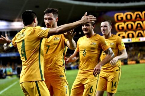 Australia's Tim Cahill, left, celebrates with teammates after scoring a goal against Jordan during their 2018 FIFA World Cup qualifier in Sydney, Australia, Tuesday, March 29, 2016.(AP Photo/Rob Griffith)