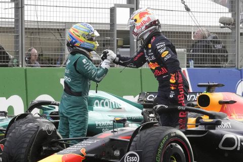 Red Bull driver Max Verstappen of the Netherlands shakes hand with second place Aston Martin driver Fernando Alonso of Spain after winning the Formula One Dutch Grand Prix at the Zandvoort racetrack, in Zandvoort, Netherlands, Sunday, Aug. 27, 2023.(AP Photo/Peter Dejong)
