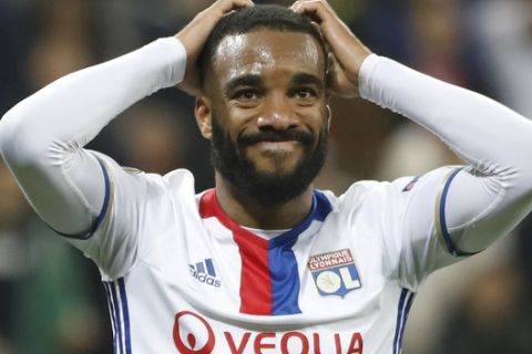 Lyon's Alexandre Lacazette grabs his head after teammate Fakir missed a chance to score during the second leg semi final soccer match between Olympique Lyon and Ajax in the Stade de Lyon, Decines, France, Thursday, May 11, 2017. (AP Photo/Laurent Cipriani)