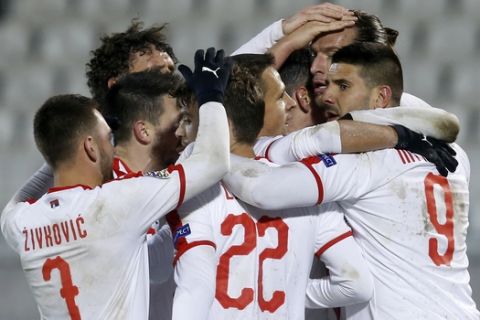 Serbia's Aleksandar Prijovic celebrates with teammates after scoring his side's third goal during the UEFA Nations League soccer match between Serbia and Lithuania at Partizan stadium in Belgrade, Serbia, Tuesday Nov. 20, 2018. (AP Photo/Darko Vojinovic)