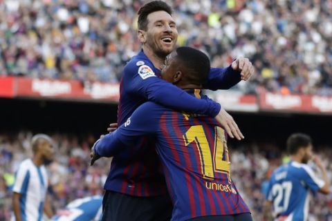 Barcelona's Lionel Messi, left, celebrates with Malcom after scoring his side's second goal during a Spanish La Liga soccer match between FC Barcelona and Espanyol at the Camp Nou stadium in Barcelona, Spain, Saturday March 30, 2019. (AP Photo/Manu Fernandez)