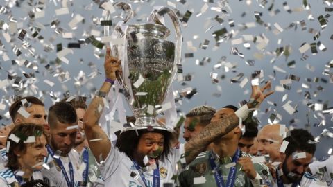 Real Madrid's Marcelo celebrates with the trophy after winning the Champions League Final soccer match between Real Madrid and Liverpool at the Olimpiyskiy Stadium in Kiev, Ukraine, Saturday, May 26, 2018. (AP Photo/Efrem Lukatsky)