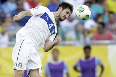Italy defender Davide Astori jumps the ball during the soccer Confederations Cup third-place match between Uruguay and Italy at Fonte Nova stadium in Salvador, Brazil, Sunday, June 30, 2013. (AP Photo/Antonio Calanni)