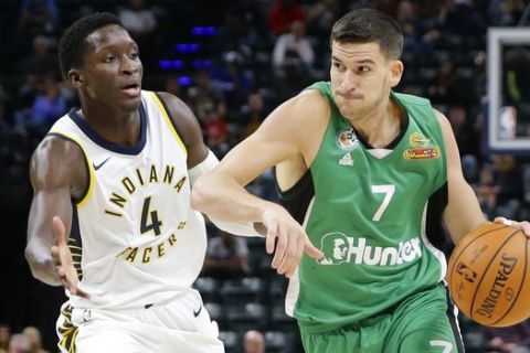 Maccabi Haifa's Frederic Bourdillon (7) drives on Indiana Pacers guard Victor Oladipo (4) during the first half of an NBA exhibition basketball game in Indianapolis, Tuesday, Oct. 10, 2017. (AP Photo/Michael Conroy)