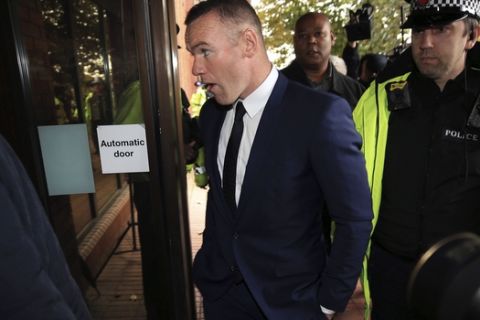 British soccer player Wayne Rooney, centre, arrives at Stockport Magistrates Court in Stockport, England, Monday, Sept. 18, 2017. The 31-year-old Everton striker is appearing in court on alleged drink driving charges.  (Peter Byrne/PA via AP)