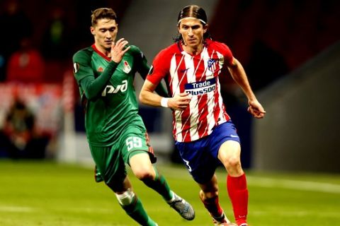Atletico Madrid's Filipe Luis, right, is challenged by Lokomotiv's Aleksei Miranchuk during the Europa League Round of 16 first leg soccer match between Atletico Madrid and Lokomotiv Moscow at the Metropolitano stadium in Madrid, Thursday, March 8, 2018. (AP Photo/Francisco Seco)