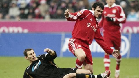 Munich's Willy Sagnol, right, from France challenges for the ball with Cottbus' Segiu Radu from Romania, during the German first division soccer match between FC Bayern Munich and Energie Cottbus at the Allianz arena  in Munich, southern Germany, Saturday, Dec. 9, 2006. (AP Photo/Uwe Lein) ** NO MOBILE USE UNTIL 2 HOURS AFTER THE MATCH, WEBSITE USERS ARE OBLIGED TO COMPLY WITH DFL-RESTRICTIONS, SEE INSTRUCTIONS FOR DETAILS ** 