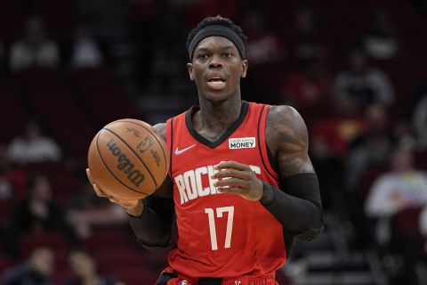 Houston Rockets' Dennis Schroder brings the ball up the court against the Los Angeles Clippers during the first half of an NBA basketball game Tuesday, March 1, 2022, in Houston. (AP Photo/David J. Phillip)