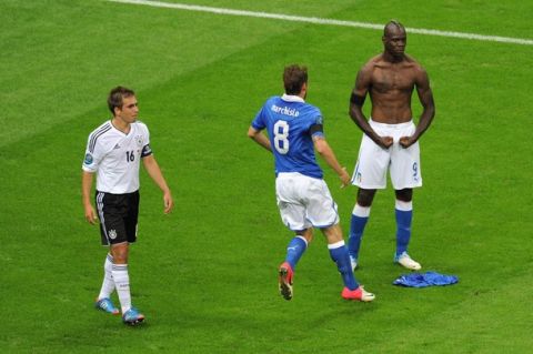 WARSAW, POLAND - JUNE 28:  Mario Balotelli (R) of Italy celebrates with team-mate Claudio Marchisio after scoring his team's second goal as Philipp Lahm of Germany shows his dejection during the UEFA EURO 2012 semi final match between Germany and Italy at the National Stadium on June 28, 2012 in Warsaw, Poland.  (Photo by Michael Regan/Getty Images)