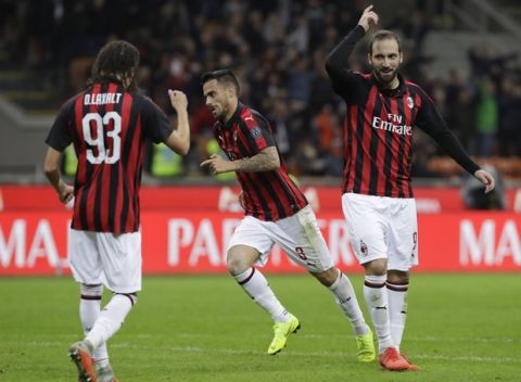 AC Milan's Suso, center, celebrates past his teammates Diego Laxalt, left, and Gonzalo Higuain after scoring his side's third goal during the Serie A soccer match between AC Milan and Sampdoria, at the San Siro stadium in Milan, Italy, Sunday, Oct. 28, 2018. (AP Photo/Luca Bruno)
