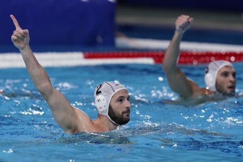 Greece's Konstantinos Genidounias (2) celebrates after scoring a goal against Montenegro during a quarterfinal round men's water polo match at the 2020 Summer Olympics, Wednesday, Aug. 4, 2021, in Tokyo, Japan. (AP Photo/Mark Humphrey)