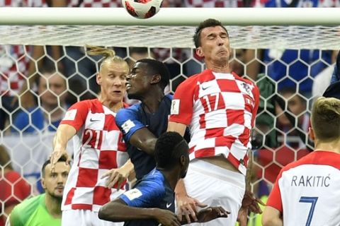 Croatia's Mario Mandzukic, 17, scores an own goal to give France the opening goal during the final match between France and Croatia at the 2018 soccer World Cup in the Luzhniki Stadium in Moscow, Russia, Sunday, July 15, 2018. (AP Photo/Martin Meissner)