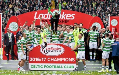 Celtic's Efe Ambrose performs an acrobatic jump as they celebrate winning the Scottish Premiership League after the match against Hearts at Celtic Park, Glasgow, Sunday May 21, 2017. (Craig Watson/PA via AP)