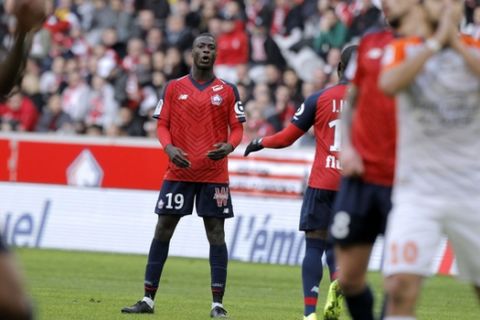 Lille's Nicolas Pepe, center, reacts during his League One soccer match match Lille and Montpellier at the Lille Metropole stadium, in Villeneuve d'Ascq, northern France, Sunday, Feb. 17, 2019. (AP Photo/Michel Spingler)