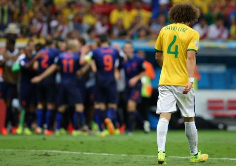 BRASILIA, BRAZIL - JULY 12:  A dejected David Luiz of Brazil walks off the pitch after a 3-0 defeat to the Netherlands during the 2014 FIFA World Cup Brazil Third Place Playoff match between Brazil and the Netherlands at Estadio Nacional on July 12, 2014 in Brasilia, Brazil.  (Photo by Dean Mouhtaropoulos/Getty Images)
