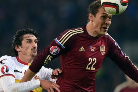 Montenegro's defender Stefan Savic (L) vies for the ball with Russia's forward Artem Dzyuba during the UEFA Euro 2016 group G qualifying football match between Russia and Montenegro at the Otkrytie Arena stadium in Moscow on October 12, 2015.  AFP PHOTO / KIRILL KUDRYAVTSEV        (Photo credit should read KIRILL KUDRYAVTSEV/AFP/Getty Images)