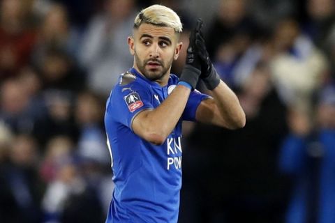 Leicester City's Riyad Mahrez gestures to the fans during the match against Sheffield United during the English FA Cup, Fifth Round soccer match at the King Power Stadium in Leicester, England, Friday Feb. 16, 2018.  Mahrez returned to Leicesters starting lineup Friday and helped the team reach the FA Cup quarterfinals, starting for the first time since the collapse of his move to Manchester City last month. (Martin Rickett/PA via AP)