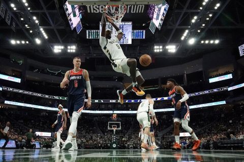 Milwaukee Bucks' Bobby Portis dunks during the second half of an NBA basketball game against the Washington Wizards Thursday, March 24, 2022, in Milwaukee. (AP Photo/Morry Gash)
