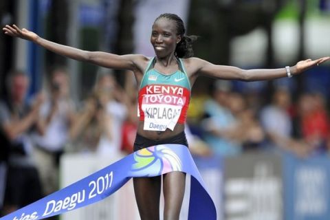Edna Kiplagat of Kenya celebrates as she wins the women's marathon final at the IAAF World Championships in Daegu August 27, 2011. REUTERS/Dylan Martinez (SOUTH KOREA  - Tags: SPORT ATHLETICS IMAGE OF THE DAY TOP PICTURE)  