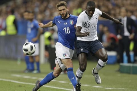 France's Benjamin Mendy, right, challenges for the ball with Italy's Domenico Berardi during a friendly soccer match between France and Italy at the Allianz Riviera stadium in Nice, southern France, Friday, June 1, 2018. (AP Photo/Claude Paris)