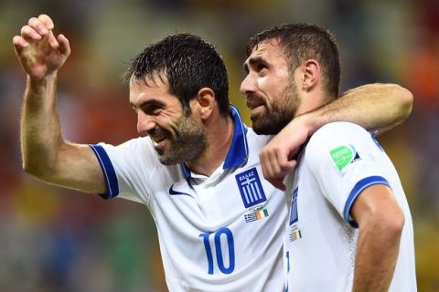FORTALEZA, BRAZIL - JUNE 24:  Giorgos Karagounis (L) and Giannis Maniatis of Greece celebrate after defeating the Ivory Coast 2-1 during the 2014 FIFA World Cup Brazil Group C match between Greece and the Ivory Coast at Castelao on June 24, 2014 in Fortaleza, Brazil.  (Photo by Laurence Griffiths/Getty Images)
