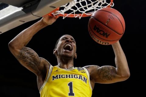 Michigan's Charles Matthews (1) dunks during the second half in the semifinals of the Final Four NCAA college basketball tournament against Loyola-Chicago, Saturday, March 31, 2018, in San Antonio. (AP Photo/David J. Phillip)