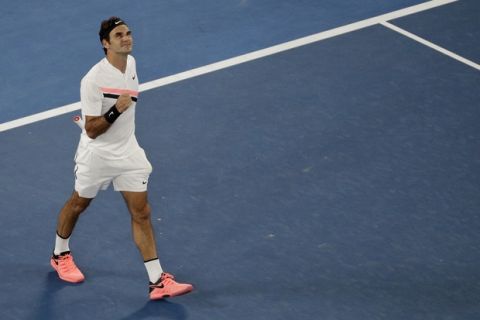 Switzerland's Roger Federer celebrates after defeating Germany's Jan-Lennard Struff during their second round match at the Australian Open tennis championships in Melbourne, Australia, Thursday, Jan. 18, 2018. (AP Photo/Dita Alangkara)