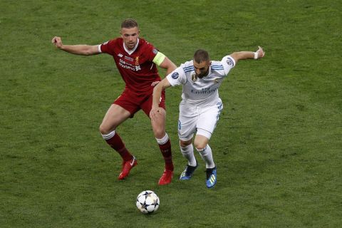 Liverpool's Jordan Henderson, left, duels for the ball with Real Madrid's Karim Benzema during the Champions League Final soccer match between Real Madrid and Liverpool at the Olimpiyskiy Stadium in Kiev, Ukraine, Saturday, May 26, 2018. (AP Photo/Darko Vojinovic)