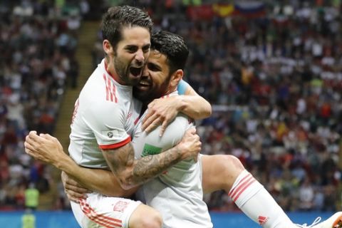 Spain's Diego Costa, right, celebrate after scoring his side's opening goal with Spain's Isco during the group B match between Iran and Spain at the 2018 soccer World Cup in the Kazan Arena in Kazan, Russia, Wednesday, June 20, 2018. (AP Photo/Frank Augstein)