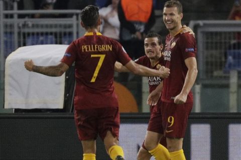 Roma forward Edin Dzeko, right, celebrate with teammates Alessandro Florenzi, center, and Lorenzo Pellegrini after scoring his team's second goal after scoring his team's second goal during a Champions League, Group G soccer match between AS Roma and CSKA Moscow, at the Olympic stadium in Rome, Tuesday, Oct. 23, 2018. (AP Photo/Gregorio Borgia)