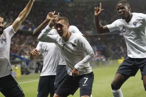 France's Antoine Griezmann, 2nd right, celebrates after scoring his side's 2nd goal with teammates : Paul Pogba, right, Corentin Tolisso and Edil Rami, left, during a friendly soccer match between France and Italy at the Allianz Riviera stadium in Nice, southern France, Friday, June 1, 2018. (AP Photo/Claude Paris)