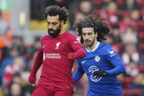 Liverpool's Mohamed Salah, left, challenges for the ball with Chelsea's Marc Cucurella during the English Premier League soccer match between Liverpool and Chelsea at Anfield stadium in Liverpool, England, Saturday, Jan. 21, 2023. (AP Photo/Jon Super)