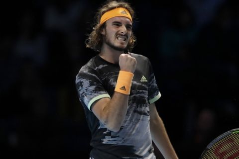 Stefanos Tsitsipas of Greece celebrates winning a point against Alexander Zverev of Germany during their ATP World Tour Finals singles tennis match at the O2 Arena in London, Wednesday, Nov. 13, 2019. (AP Photo/Kirsty Wigglesworth)