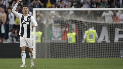 Juventus' Cristiano Ronaldo celebrates at the end of a Serie A soccer match between Juventus and AC Fiorentina, at the Allianz stadium in Turin, Italy, Saturday, April 20, 2019. Juventus clinched a record-extending eighth successive Serie A title, with five matches to spare, after it defeated Fiorentina 2-1. (AP Photo/Luca Bruno)
