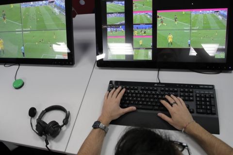 A referee demonstrates a video operation room (VOR), a facility of the Video Assistant Referee (VAR) system which will be rolled out for the first time during the World Cup, at the 2018 World Cup International Broadcast Centre in Moscow, Russia, Saturday, June 9, 2018. (AP Photo/Dmitri Lovetsky)