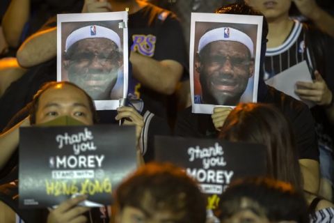 Demonstrators hold up photos of LeBron James grimacing during a rally at the Southorn Playground in Hong Kong, Tuesday, Oct. 15, 2019. Protesters in Hong Kong have thrown basketballs at a photo of LeBron James and chanted their anger about comments the Los Angeles Lakers star made about free speech during a rally in support of NBA commissioner Adam Silver and Houston Rockets general manager Daryl Morey, whose tweet in support of the Hong Kong protests touched off a firestorm of controversy in China. (AP Photo/Mark Schiefelbein)