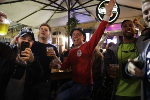 Liverpool supporters sing and support their team in a pub in Rome's historical Campo de' Fiori square, Tuesday, May 1, 2018. Liverpool will face AS Roma in the second leg of the Champions League semifinals on Wednesday. (AP Photo/Andrew Medichini)