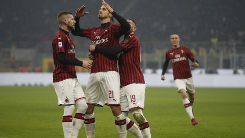 AC Milan's Zlatan Ibrahimovic, centre, celebrates with his teammates after he scored his side's second goal during the Serie A soccer match between Inter Milan and AC Milan at the San Siro Stadium, in Milan, Italy, Sunday, Feb. 9, 2020. (AP Photo/Antonio Calanni)