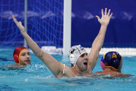 Greece's Alexandros Papanastasiou, center, gestures for a foul to be called after a play during a quarterfinal round men's water polo match against Montenegro at the 2020 Summer Olympics, Wednesday, Aug. 4, 2021, in Tokyo, Japan. (AP Photo/Mark Humphrey)
