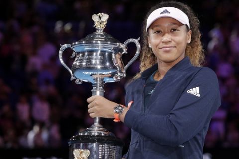 Japan's Naomi Osaka poses with trophy after defeating Petra Kvitova of the Czech Republic in the women's singles final at the Australian Open tennis championships in Melbourne, Australia, Saturday, Jan. 26, 2019. (AP Photo/Aaron Favila)