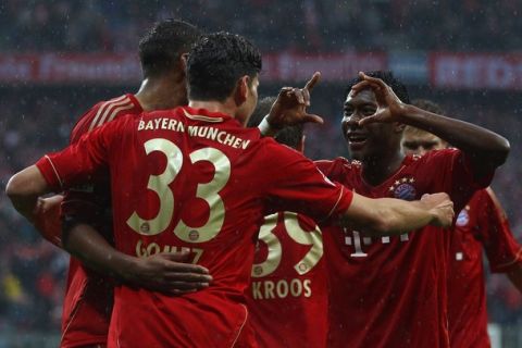 MUNICH, GERMANY - MARCH 24:  Mario Gomez (C) of Muenchen celebrates scoring the second team goal with his team mate David Alaba (R) during the Bundesliga match between FC Bayern Muenchen and Hannover 96 at Allianz Arena on March 24, 2012 in Munich, Germany.  (Photo by Alexander Hassenstein/Bongarts/Getty Images)