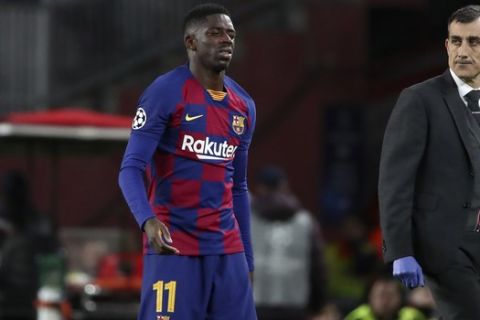 Barcelona's Ousmane Dembele leaves the field after getting injured during a Champions League group F soccer match between Barcelona and Borussia Dortmund at the Camp Nou stadium in Barcelona, Spain, Wednesday, Nov. 27, 2019. (AP Photo/Emilio Morenatti)