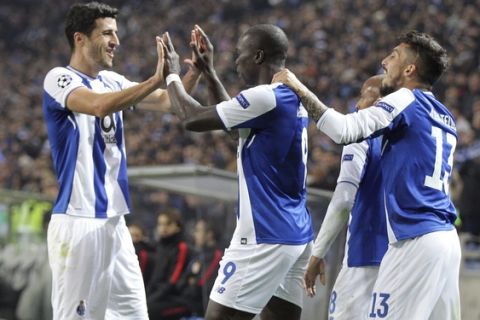 Porto's Vincent Aboubakar, center, celebrates with Ivan Marcano, left, after scoring his side's second goal during the Champions League group G soccer match between FC Porto and AS Monaco at the Dragao stadium in Porto, Portugal, Wednesday, Dec. 6, 2017. (AP Photo/Luis Vieira)