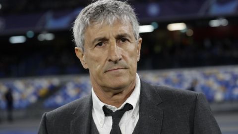 Barcelona coach Quique Setien waits for the start of the Champions League, Round of 16, first-leg soccer match between Napoli and Barcelona, at the San Paolo Stadium in Naples, Italy, Tuesday, Feb. 25, 2020. (AP Photo/Andrew Medichini)