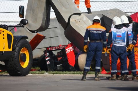 SOCHI, RUSSIA - OCTOBER 10:  Course marshalls remove barriers from the top of Carlos Sainz of Spain and Scuderia Toro Rosso's damaged car after he crashed during final practice for the Formula One Grand Prix of Russia at Sochi Autodrom on October 10, 2015 in Sochi, Russia.  (Photo by Clive Mason/Getty Images)