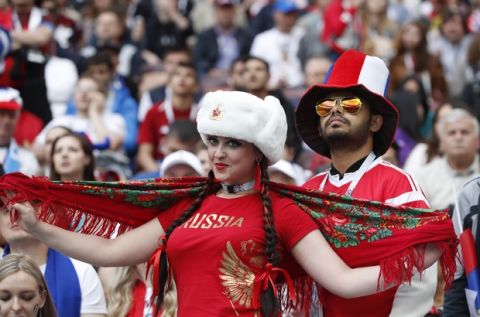 Russian fans get ready to cheer on their side as they pose a photograph before the start of the group A match between Russia and Saudi Arabia which opens the 2018 soccer World Cup at the Luzhniki stadium in Moscow, Russia, Thursday, June 14, 2018. (AP Photo/Antonio Calanni)