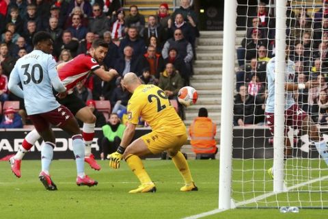 Southampton's Shane Long, second left, scores his side's first goal of the game against Aston Villa during their English Premier League soccer match at St Mary's Southampton, England, Saturday Feb. 22, 2020. (Mark Kerton/PA via AP)